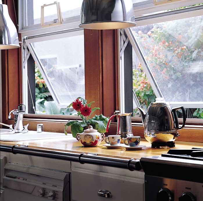 Butcher-block countertops are a cook’s dream—practical yet beautiful. Jana and Claudio have amassed an eclectic collection of pottery from their many trips to Italy. Views from the kitchen window include an ever-flowering bougainvillea bush and squirrels and birds feeding at the fence.